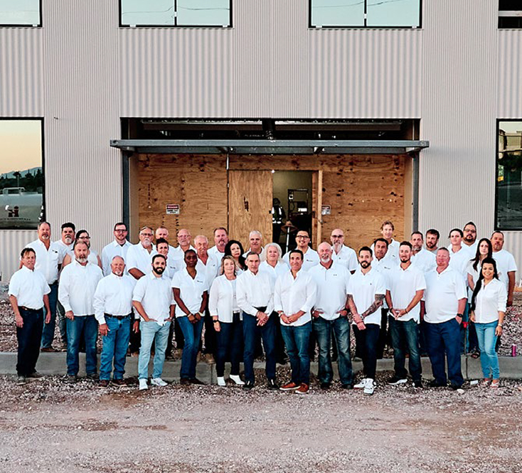 The entire Kalb Construction team standing in front of another project